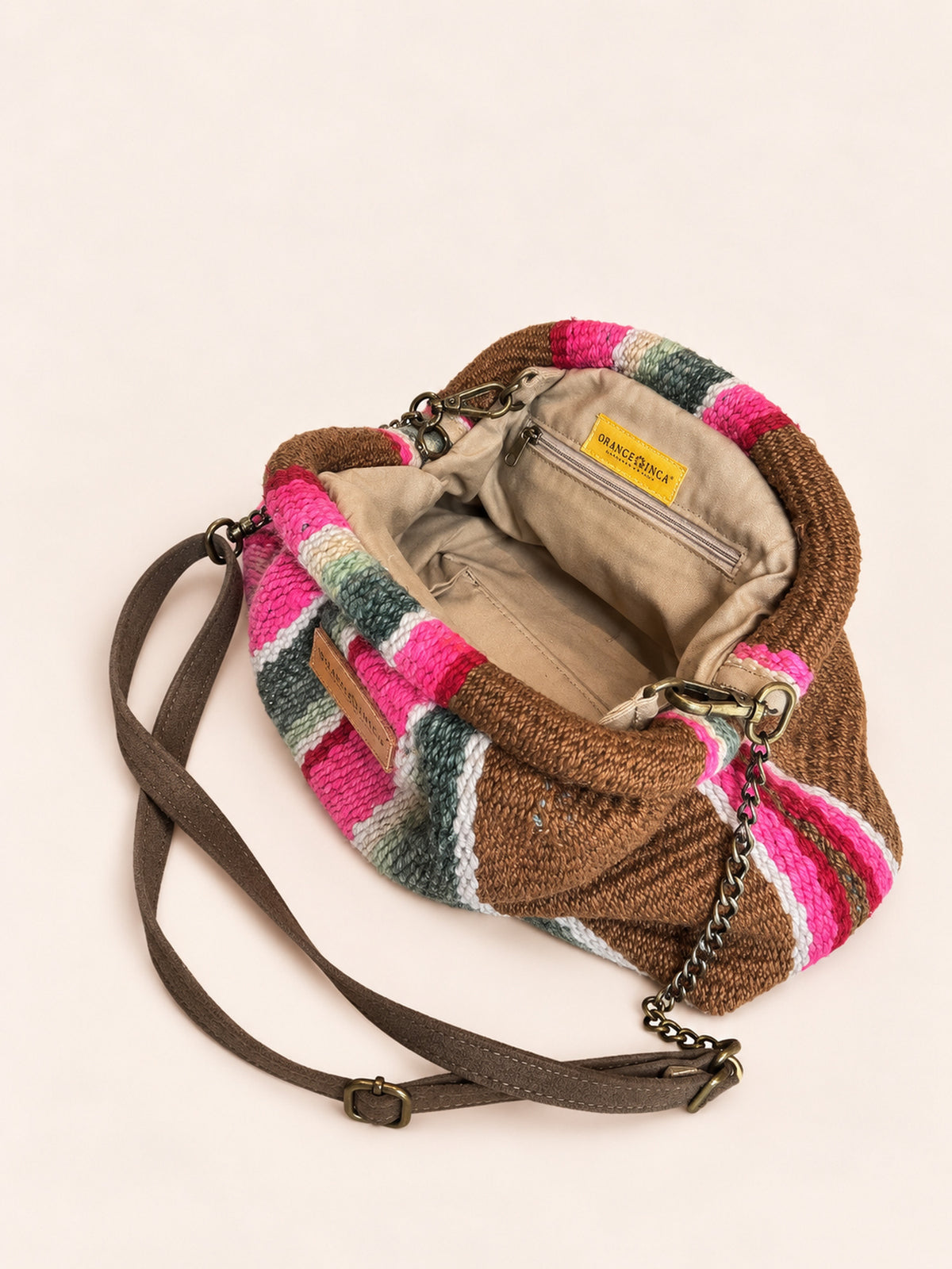 Inside the Luna kiss lock clutch in browns, fuchsia and greens – cotton drill lining, zip pocket and detachable faux suede and chain strap | Orange Inca