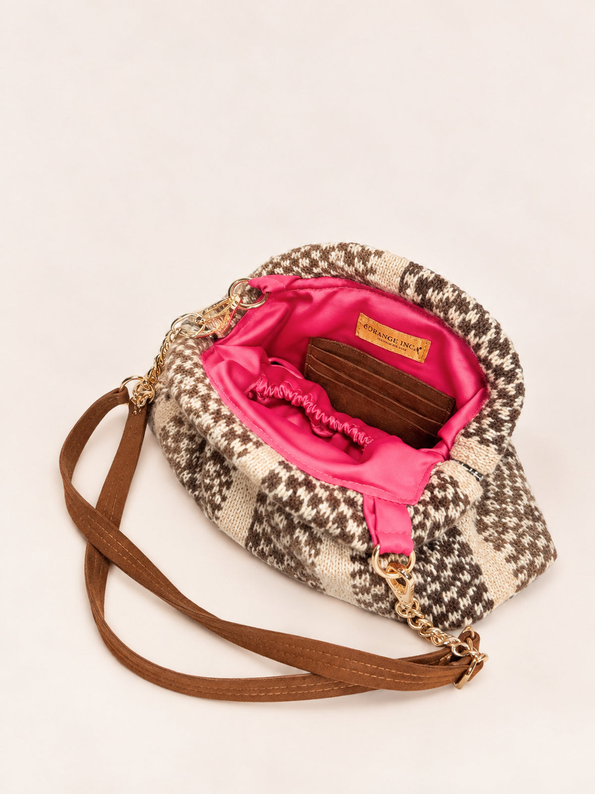 Inside the Luna kiss lock clutch in browns and camel – fuchsia lining, card slots and detachable faux suede and chain strap | Orange Inca