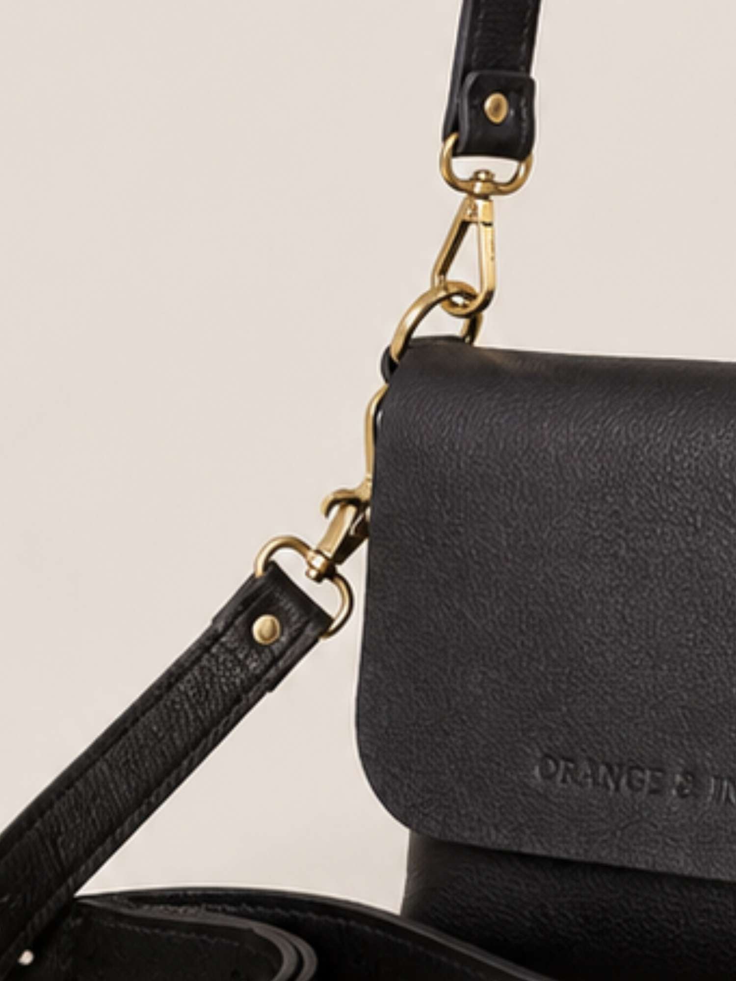 Black Olivia close-up — tumbled leather detail with antique brass hardware | Orange Inca