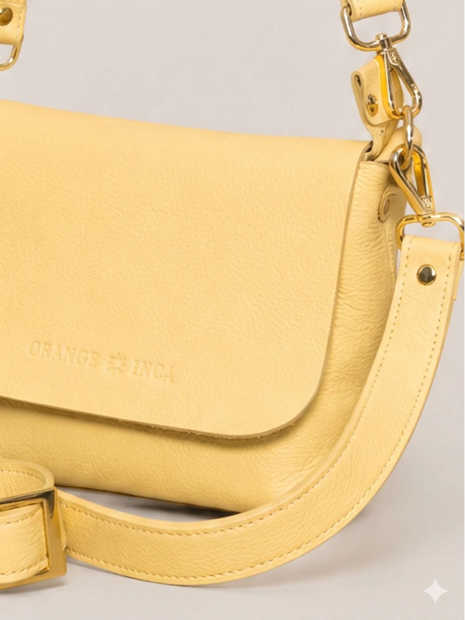 Butter Yellow Olivia close-up — tumbled leather detail with polished gold hardware | Orange Inca