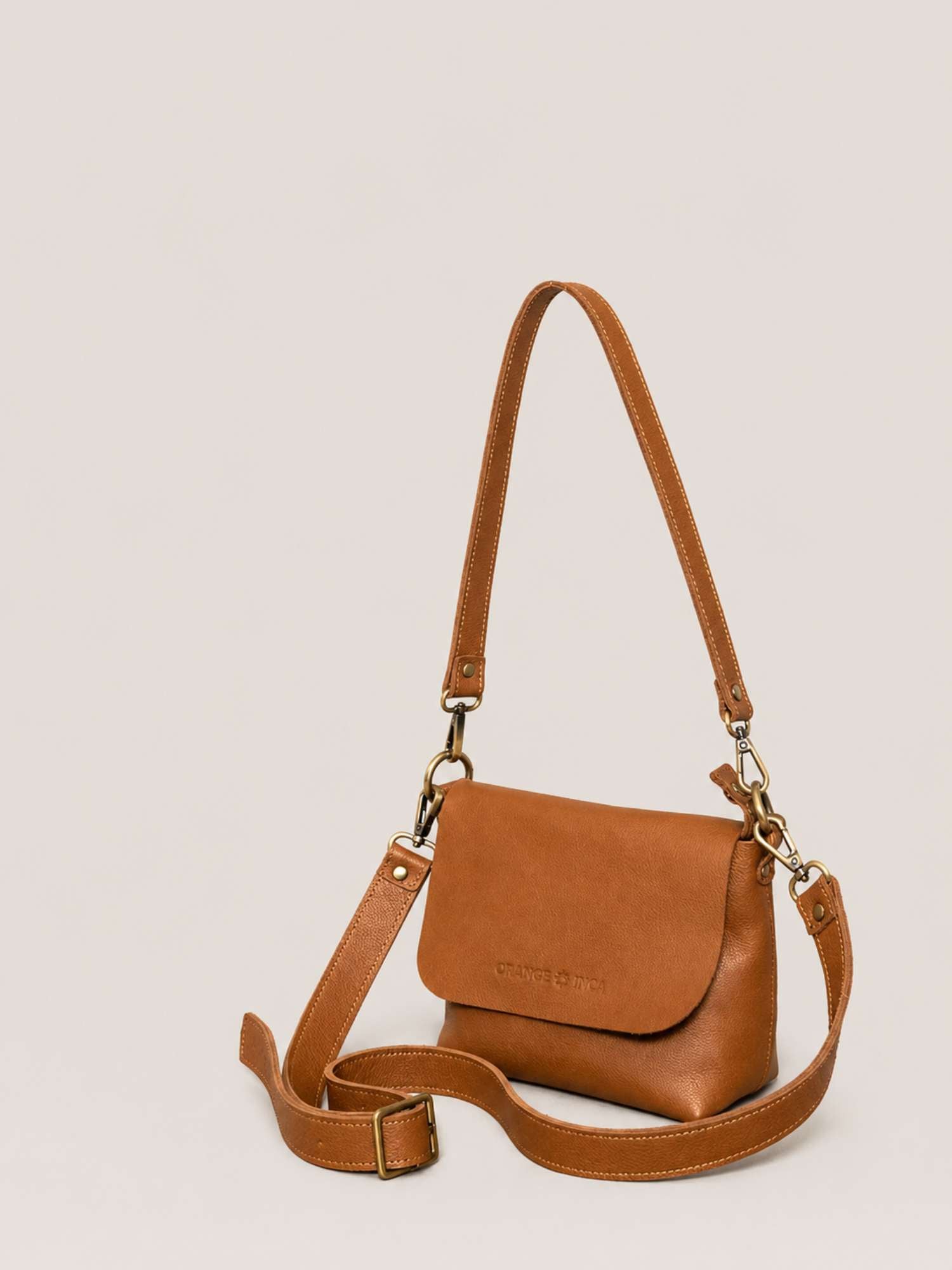 The Olivia Cognac leather crossbody — both straps shown (shoulder + crossbody) | Orange Inca