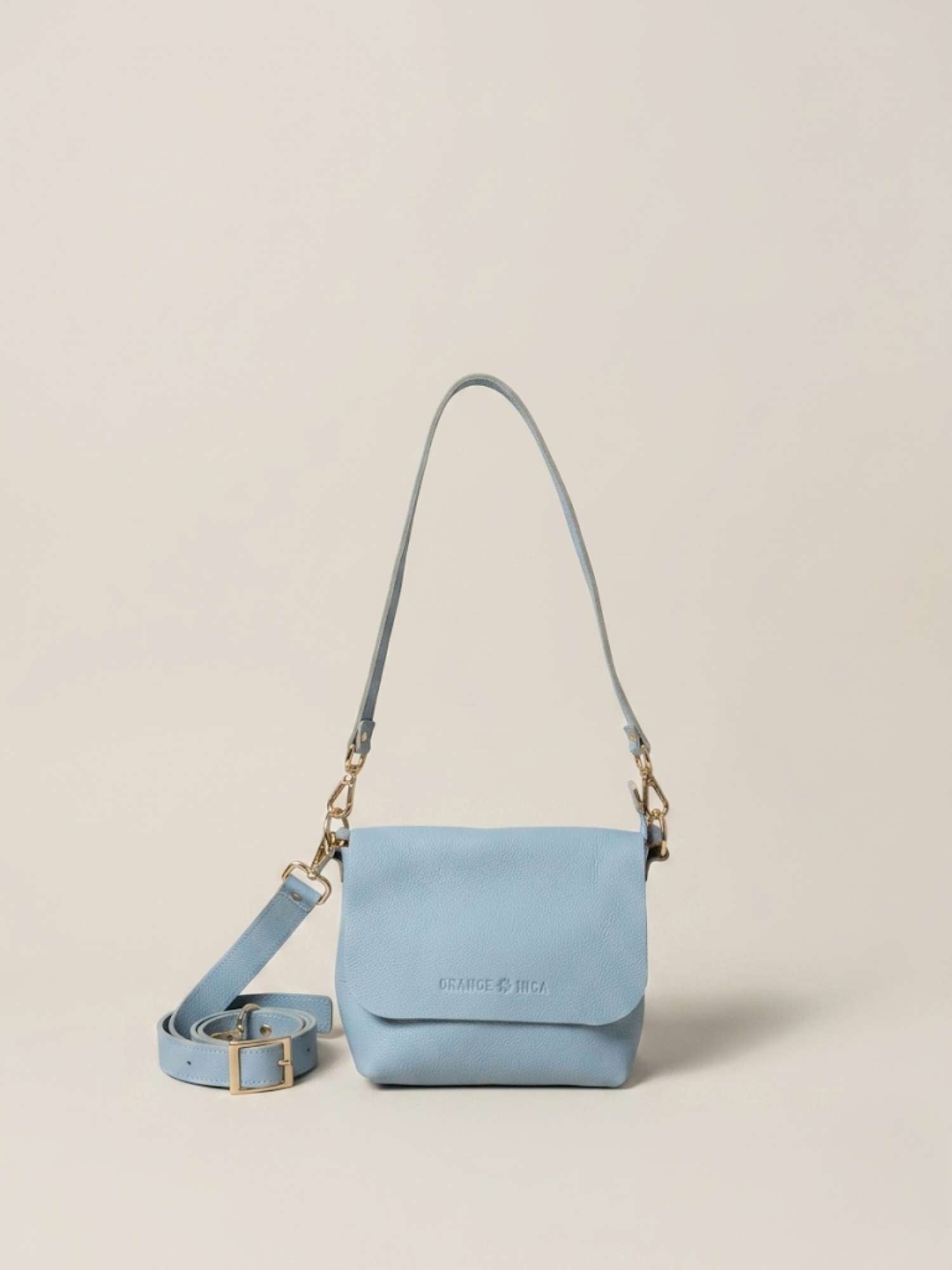 Powder Blue full-grain leather crossbody by Orange Inca — front with strap coiled | Orange Inca