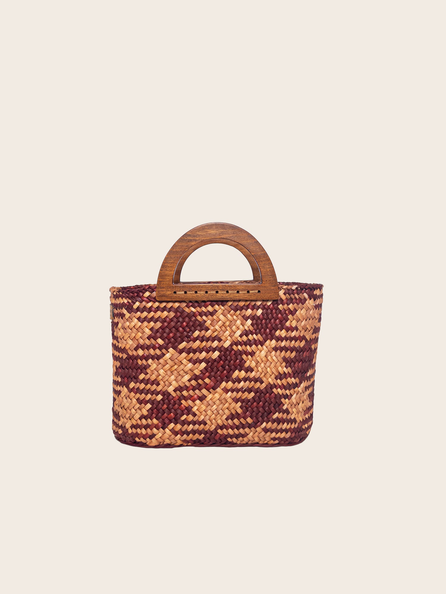 The Sophia bag in camel and beige, handwoven with a wooden handle, showcasing a colorful earthy design.
