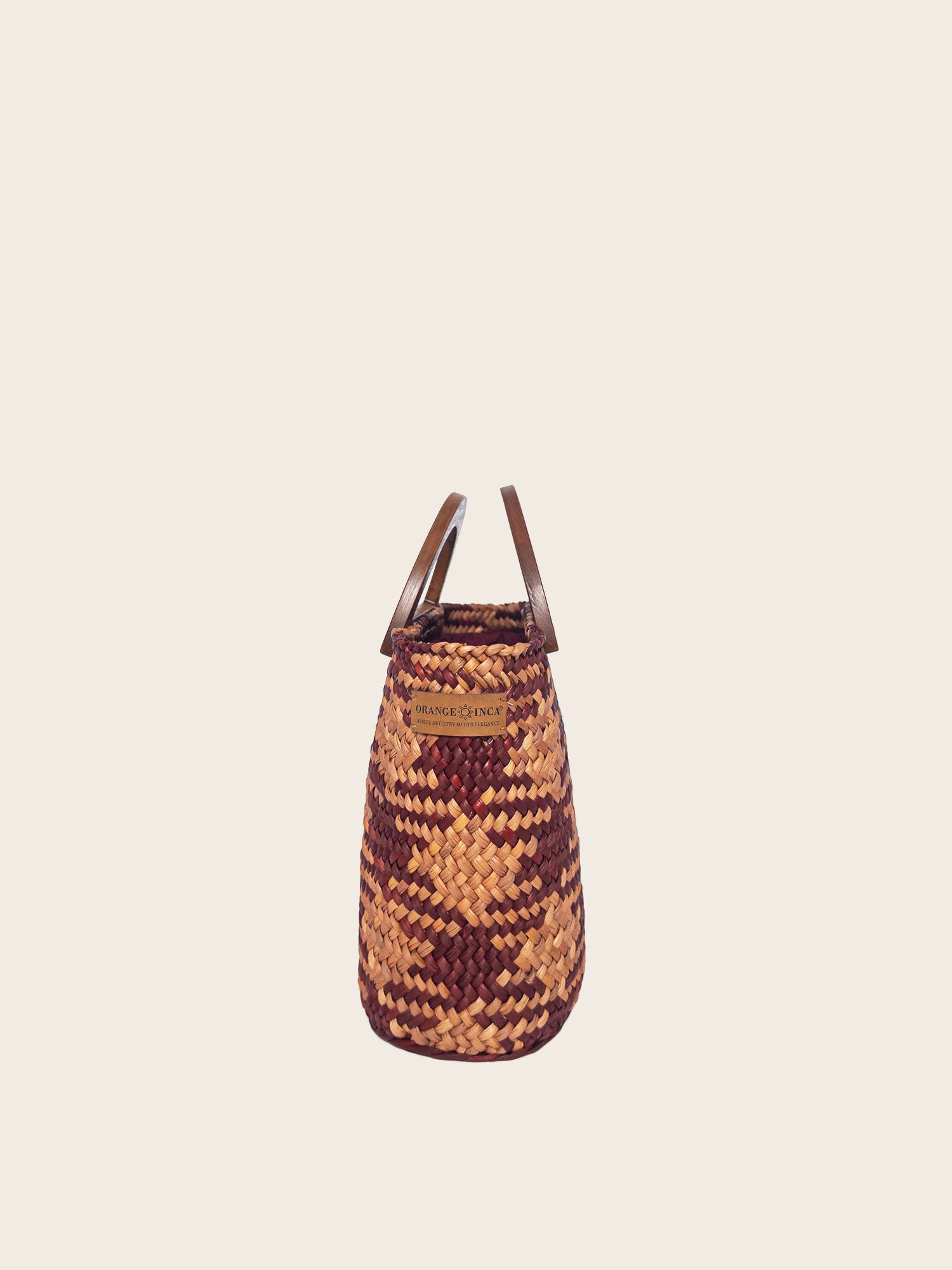The Sophia bag in camel and beige, handwoven design with solid wood handles and internal drawstring closure.