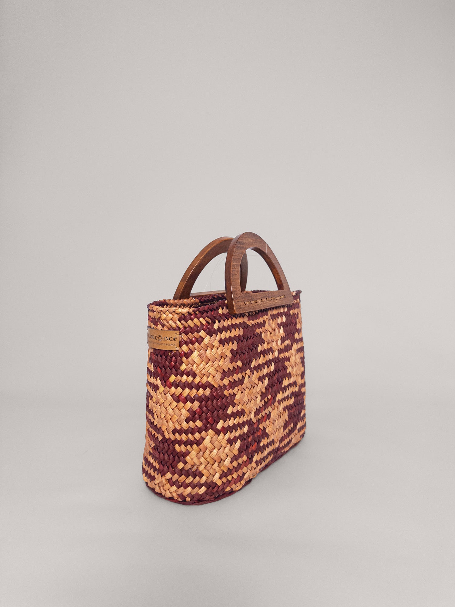 The Sophia handwoven bag in earthy tones of camel and beige with solid wood handles, stylish and spacious design.