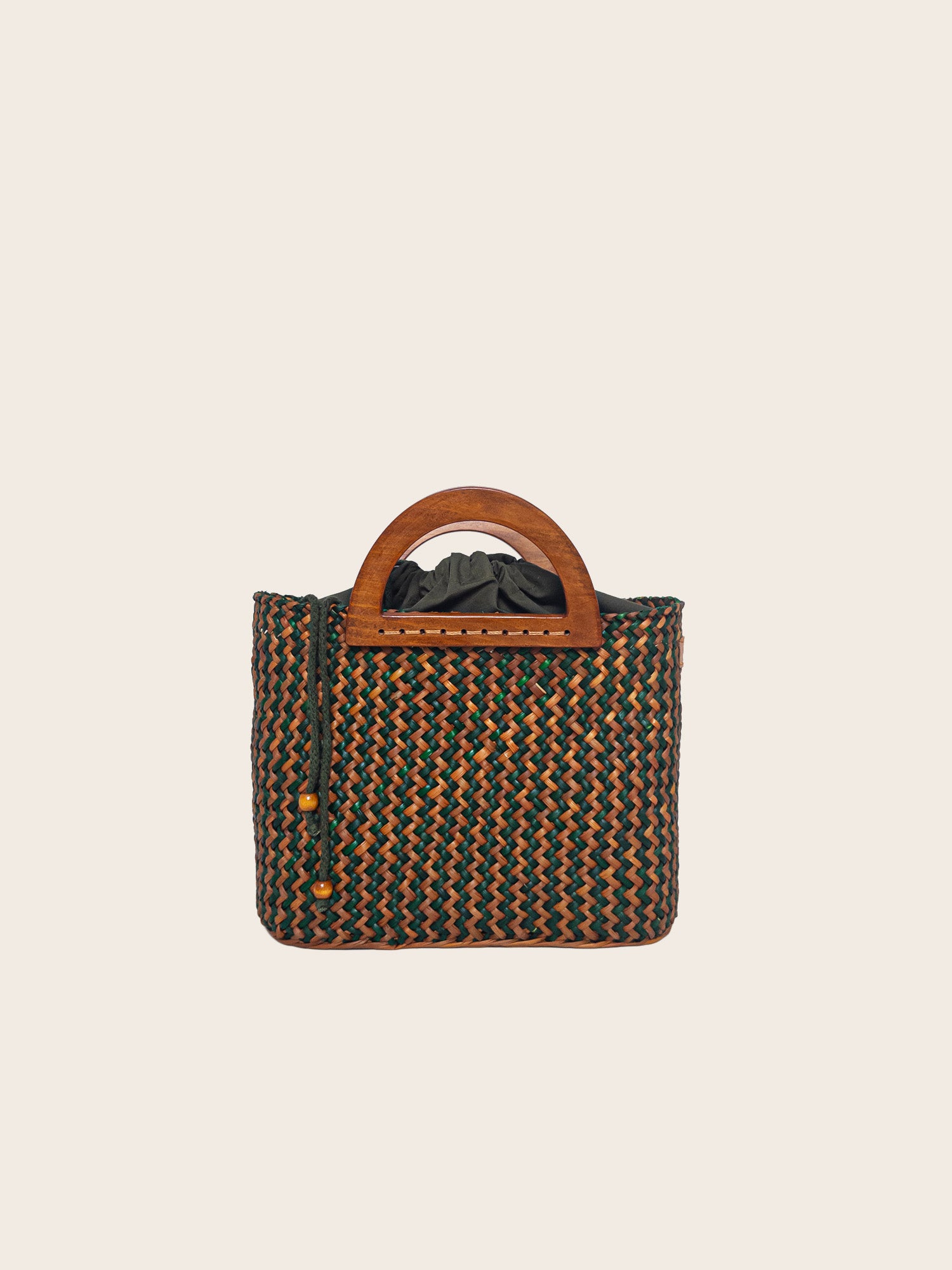 The Sophia bag in olive green and camel, handwoven with wooden handles and a spacious interior.