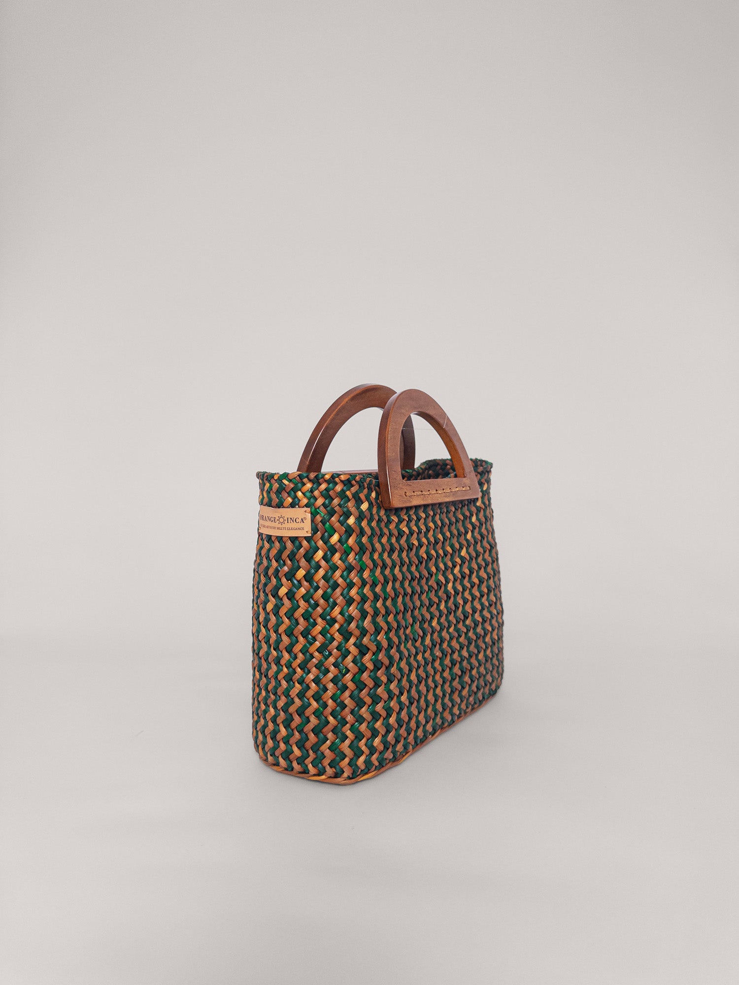 The Sophia bag in olive green and camel with wooden handles, showcasing its handwoven texture and stylish design.