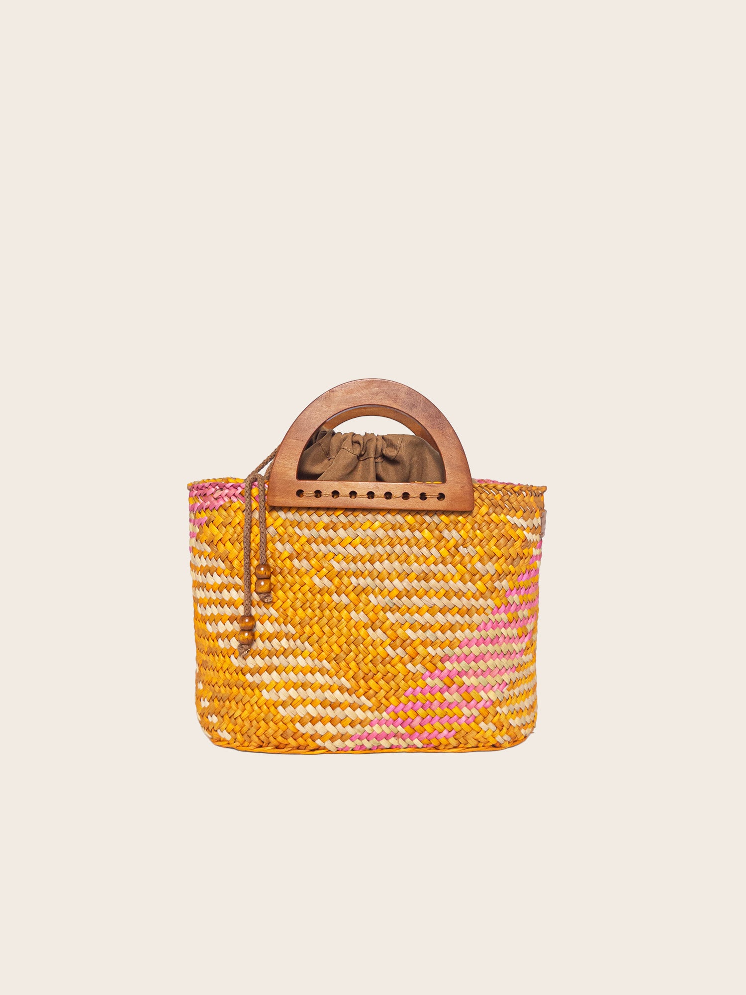 The Sophia handbag in washed yellow and pink, handwoven with wooden handles and cotton lining.