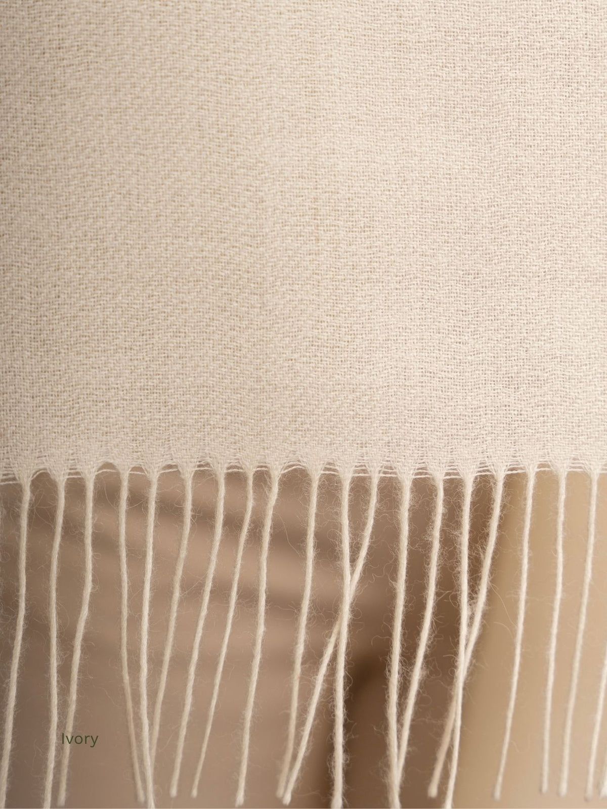 Close-up of the twisted fringe on an ivory undyed baby alpaca shawl, fine Peruvian alpaca weave